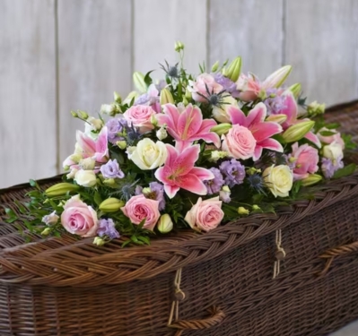 Pink lily and rose casket spray
