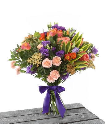 Bright hand tied bouquet made with seasonal flowers