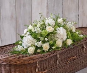 Delicate white casket spray