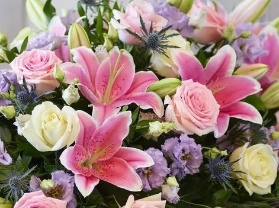 Pink lily and rose casket spray