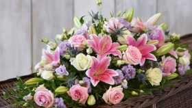 Pink lily and rose casket spray